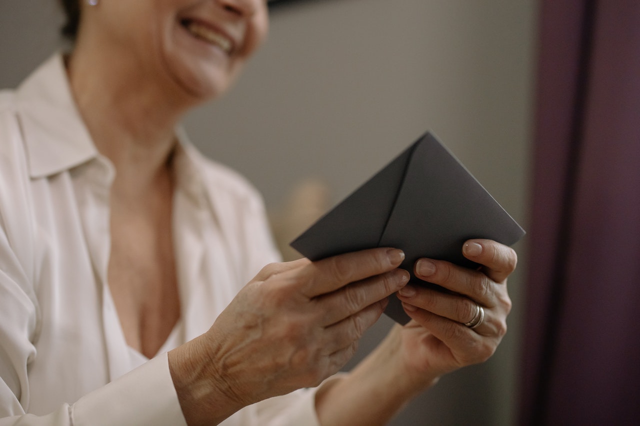 Smiling woman holding a letter